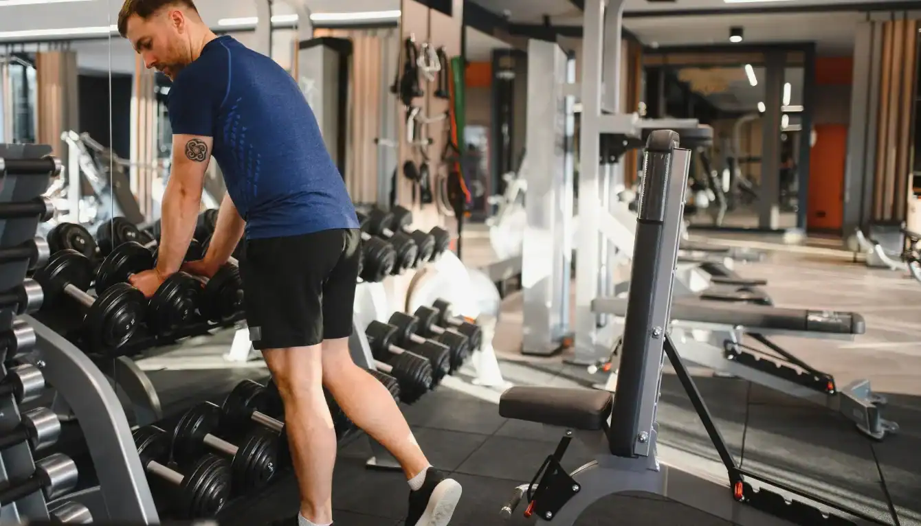 evening workout best time, diverse adults strength training in gym at night